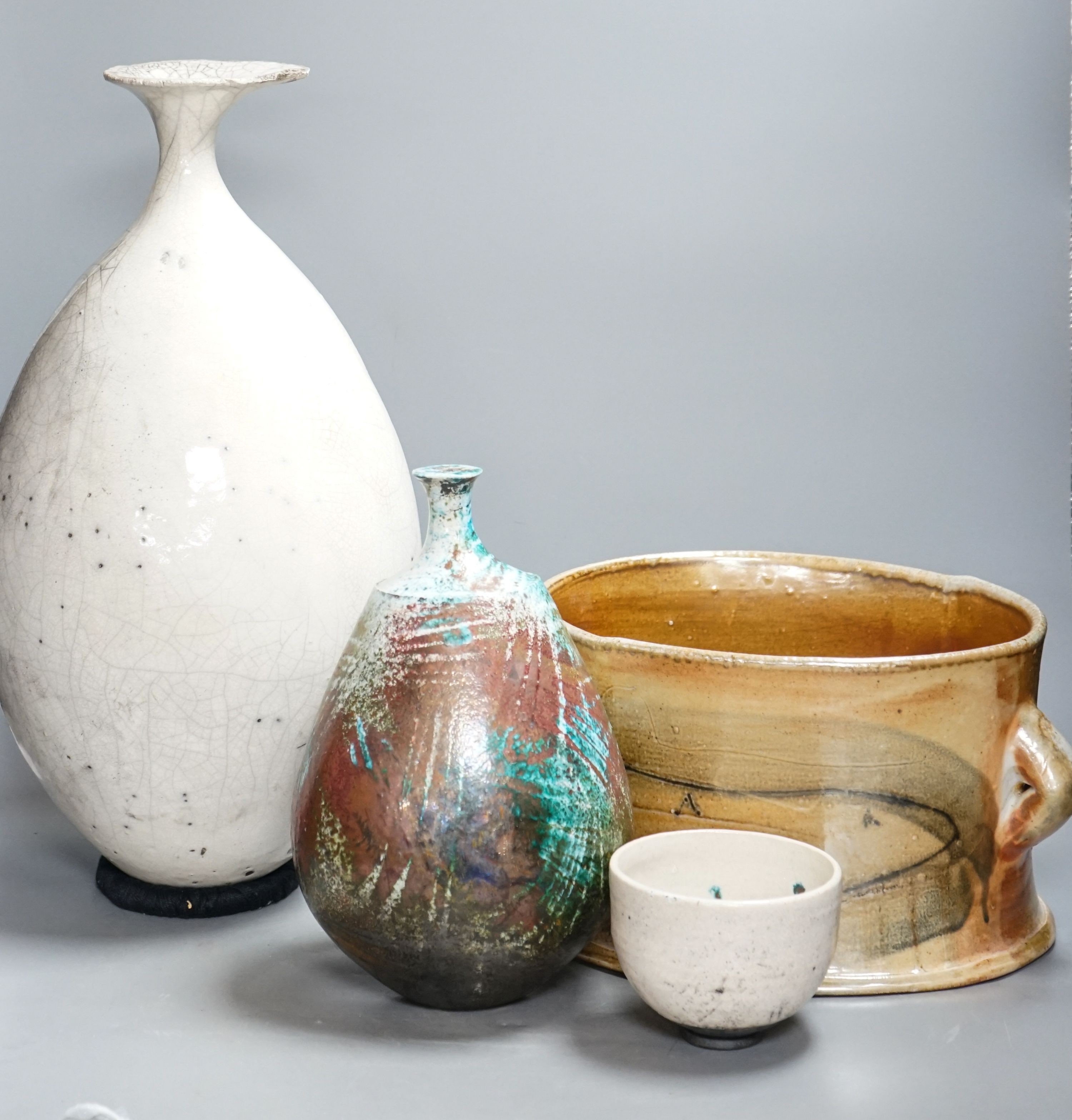 Studio pottery- an Allison Weightman raku fired large albastron form vase, ovoid vase and cup and a Petra Reynolds oval stoneware pot (4) Tallest 44cm